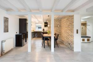 a kitchen and dining room with a table and a brick wall at Grünes Tal - Seenah in Stockach