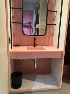 a bathroom with a pink sink and a mirror at Artsy Vitoria Hostel in Vitória +38 photos