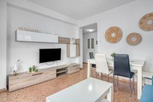a living room with a tv and a table and chairs at Brooklyn in Oliva