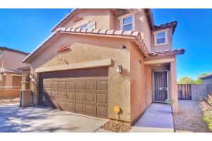a brown house with a garage and a driveway at Spacious Desert Suite Minutes to Phoenix Fun - Pet Friendly! in Avondale