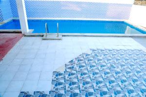 a swimming pool with two poles in the middle of it at ECR Holiday in Chennai