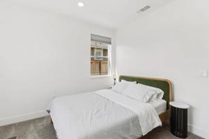 a white bedroom with a bed and a window at Monthly or Daily Stay in Spacious 4BD for Family or Work with Outdoor backyard and BBQ grill in Folsom