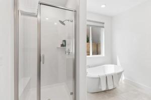 a white bathroom with a shower and a sink at Monthly or Daily Stay in Spacious 4BD for Family or Work with Outdoor backyard and BBQ grill in Folsom +48 photos