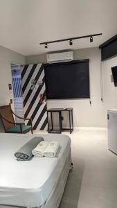a room with a bed and a projection screen at Artsy Vitoria Hostel in Vitória