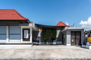 a small house with a red roof at Blue Marlin Villas Legian in Legian