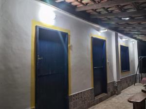 a row of three doors in a room at Fazenda São Leandro in Rio das Flores