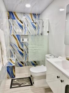 a bathroom with a toilet and a sink at HOTEl LIRIOS DEL MAR in Santo Domingo +16 photos