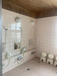 a bathroom with two toilets and a shower at Yubari Forest Farm BandB in Yubari