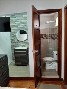 a bathroom with a shower and a toilet and a sink at Casona Feran in Pasto