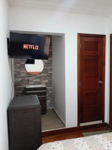a kitchen with a netflix sign in a room at Casona Feran in Pasto