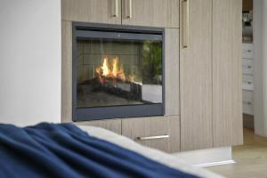a fireplace with a fire in it in a room at Secluded rainforest getaway in Currumbin Valley