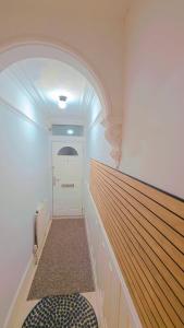 a room with a hallway with a white door at Legoland Room in Bearsted