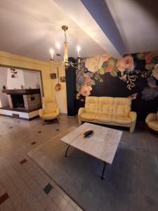 a living room with a couch and a table at chez cadet in Larzicourt