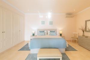 a large bedroom with a bed and a dresser at Macondo Altea Hills in Altea +30 photos