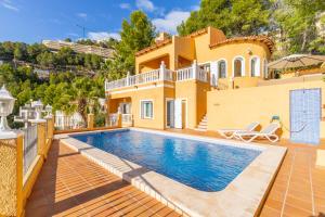 a villa with a swimming pool and a house at Macondo Altea Hills in Altea