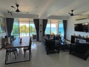 a dining room with a table and chairs and the ocean at Luxury Penthouse, Beachfront, Nilaveli in Trincomalee