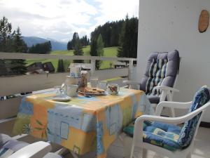 a table and two chairs on a balcony at Sonnenalm - Ferienwohnung in Reith +4 photos