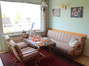 a living room with a couch and a table at Sonnenalm - Ferienwohnung in Reith