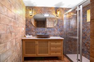 a bathroom with a sink and a shower at Casas do Monte I - T2 in Mértola +28 photos