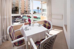 a dining room with a table and chairs and a window at Estudio Bloque 89 in Torrox