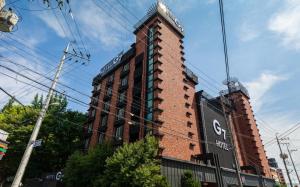 a brick building with a sign on the side of it at Iksan Hotel G7 in Songman