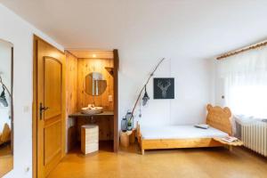 a room with a bed and a sink in it at Haus Winterberg in Schonach +43 photos