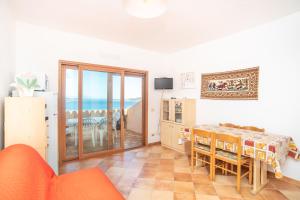 a living room with a table and a view of the ocean at Flat Orizzonte in Palau