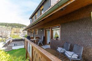 a porch of a house with chairs and a table at Haus Winterberg in Schonach