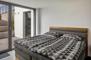a bedroom with a bed and a sliding glass door at Ferienwohnung im Obstgarten in Ihringen