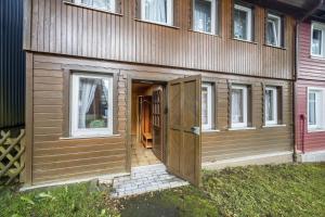 a wooden shed with a door on the side of a house at Ferienhaus Bergmannsruh in Clausthal-Zellerfeld