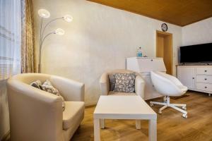 a living room with two chairs and a table at Ferienhaus Bergmannsruh in Clausthal-Zellerfeld