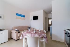 a living room with a table and a couch at Casa d'a mare in Torre San Giovanni Ugento