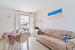 a living room with a couch and a table at Casa d'a mare in Torre San Giovanni Ugento