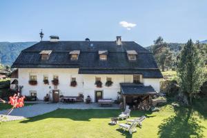 a large white house with a large yard at Oberwieserhof App 1 in San Lorenzo di Sebato