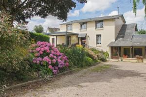 a house with pink flowers in front of it at Chambres Paysannes Lecarpentier - in Fontenay +9 photos