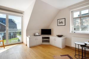 a white room with a desk with a computer on it at Haus Schilfblick in Wieck