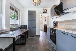 a kitchen with a wooden table and a counter top at Ferienhaus Magda in Stadum