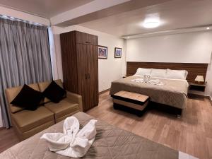 a hotel room with a bed and a couch at Inca Wasi Plaza de Armas in Cusco