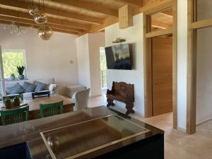 a kitchen and living room with a couch and a table at Casa Tapeo in Schiefling am See