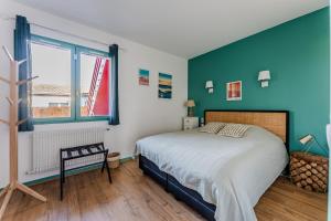 a bedroom with a large bed and a window at Chambre D'hote Chez Amaya in Gujan-Mestras