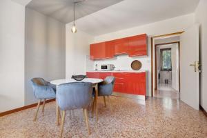 a kitchen with red cabinets and a table and chairs at Apartment Jose in Tremosine Sul Garda