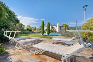 a patio with two benches and a pool at Apartment Jose in Tremosine Sul Garda