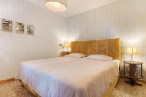 a bedroom with a large white bed with two pillows at Apartment Jose in Tremosine Sul Garda +27 photos