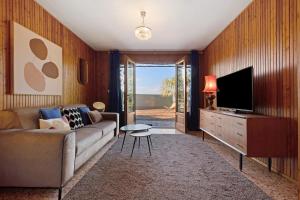 a living room with a couch and a television at Apartment Jose in Tremosine Sul Garda