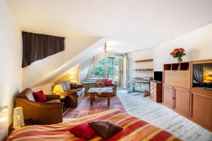 a bedroom with a bed and a living room at Ferienwohnung Weitblick in Bad Liebenzell