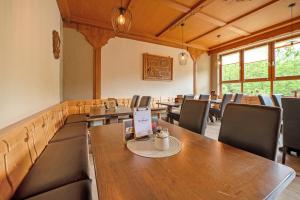 a room with rows of tables and chairs at Gästezimmer St Wendel in Prüm