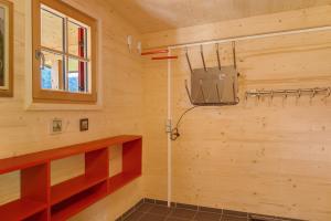 a bathroom with a shower in a wooden wall at Chalet87 in Berwang