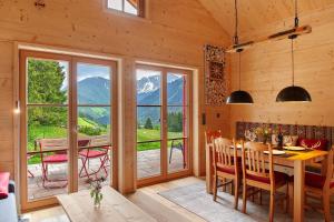 a dining room with a table and a large window at Chalet87 in Berwang