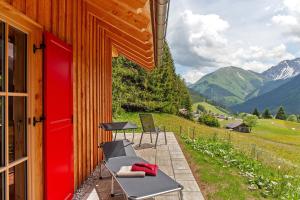 a patio with chairs and a table and a building at Chalet87 in Berwang