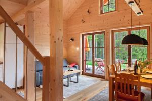 a wooden cabin with a dining room and a dining table at Chalet87 in Berwang +21 photos